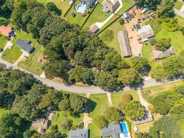 an aerial view of beach and residential houses with outdoor space