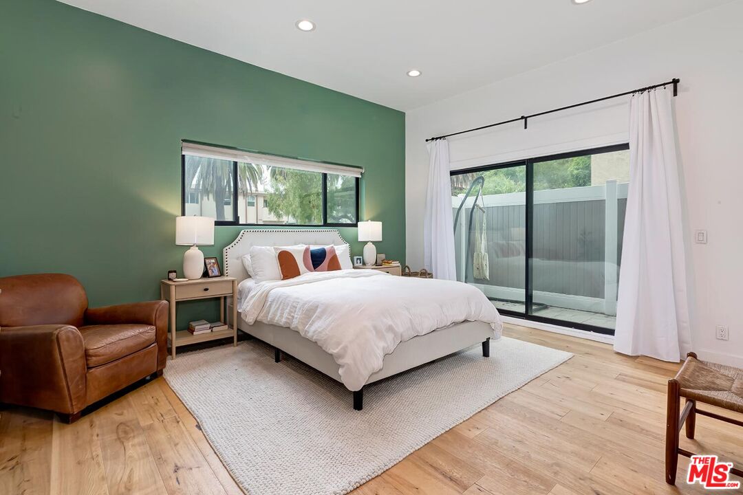 1131 12th Street, Unit 101 Santa Monica, CA 90403 - Photo 11 of 21 a bedroom with a bed and glass window