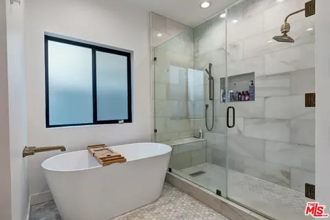a bathroom with a double vanity sink mirror and shower