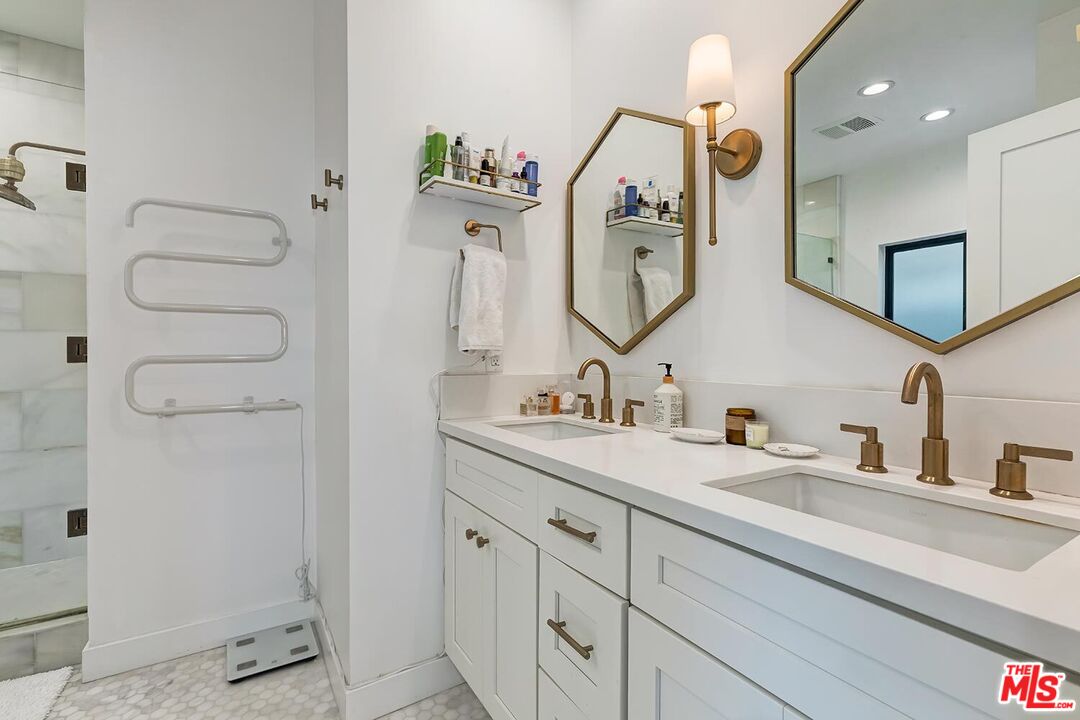 1131 12th Street, Unit 101 Santa Monica, CA 90403 - Photo 15 of 21 a bathroom with a double vanity sink mirror and shower