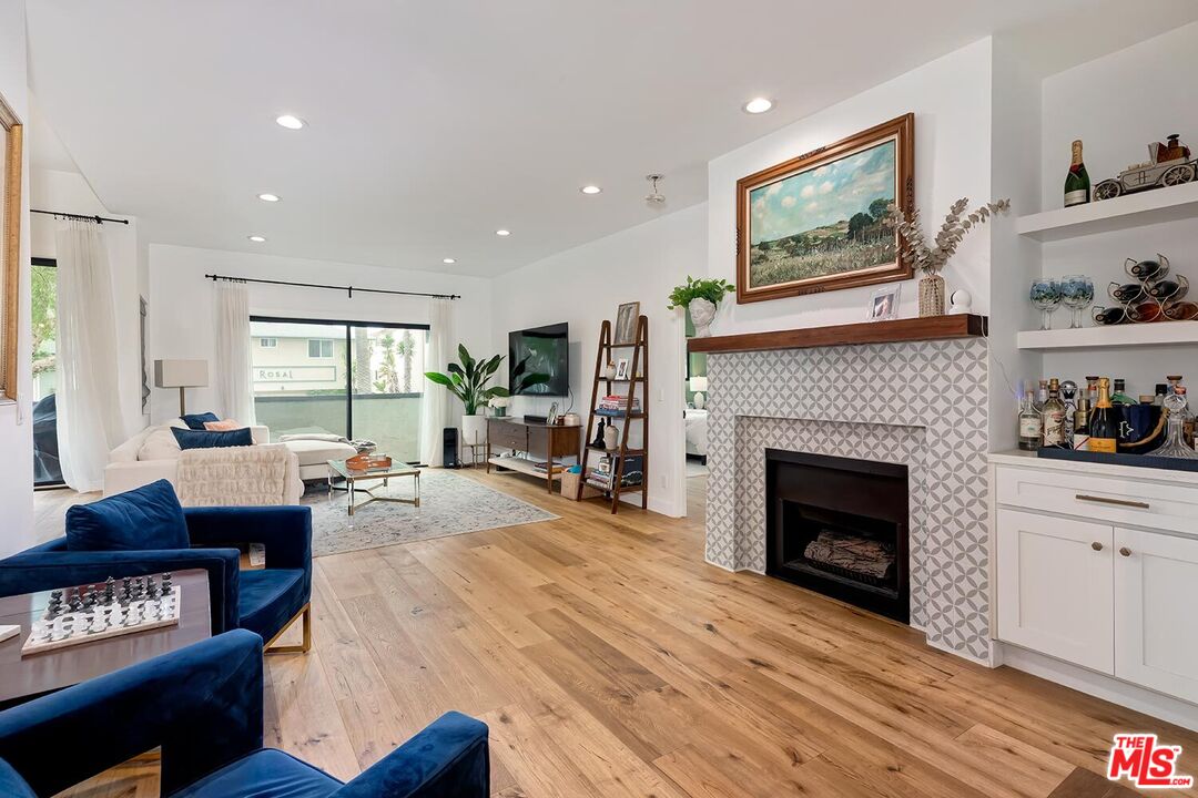 1131 12th Street, Unit 101 Santa Monica, CA 90403 - Photo 2 of 21 a living room with furniture and a fireplace
