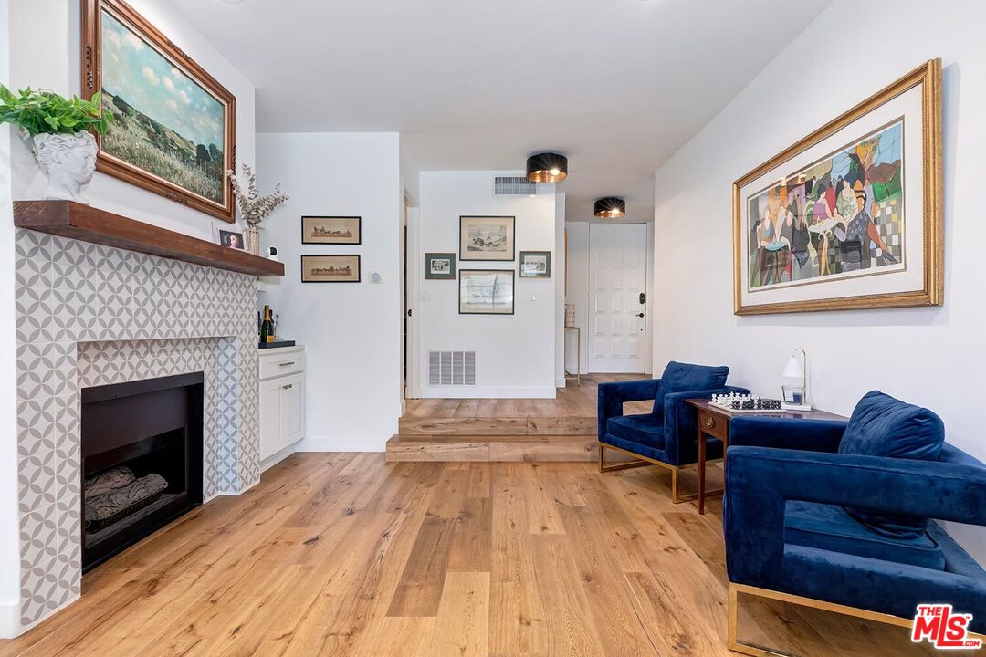 1131 12th Street, Unit 101 Santa Monica, CA 90403 - Photo 3 of 21 a living room with furniture and a fireplace