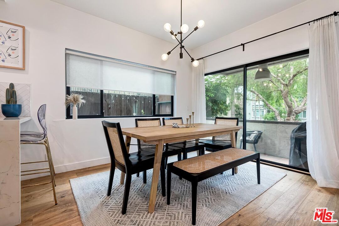 1131 12th Street, Unit 101 Santa Monica, CA 90403 - Photo 6 of 21 a view of a dining room with furniture window and wooden floor