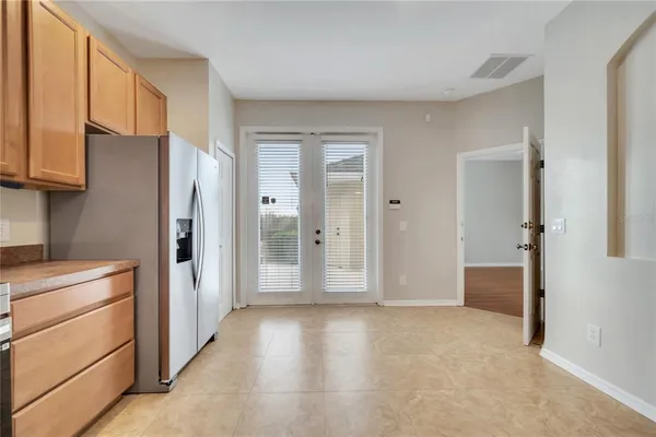 a view of a kitchen with a refrigerator cabinets and a wooden floor