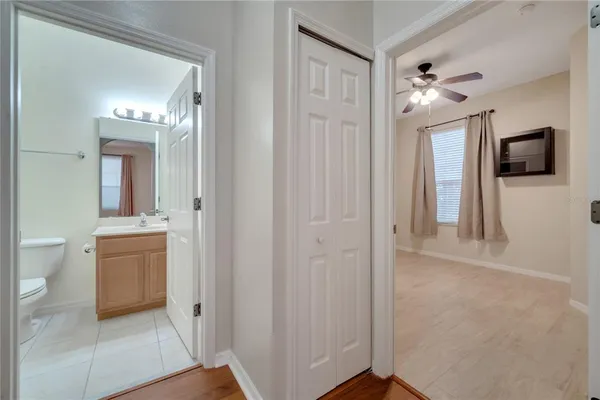 a view of a hallway and a livingroom with wooden floor