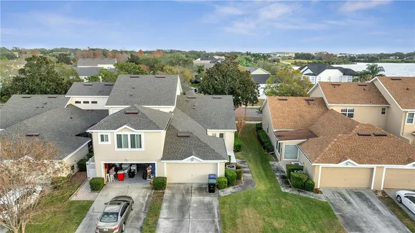 an aerial view of residential houses with outdoor space and street view