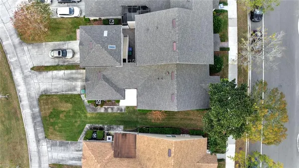 an aerial view of a house with a yard