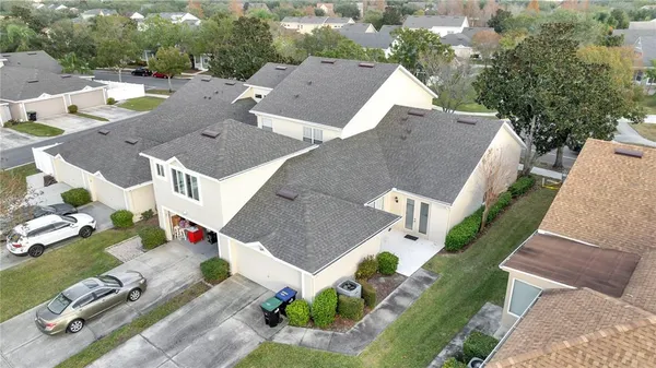 an aerial view of multiple houses with yard