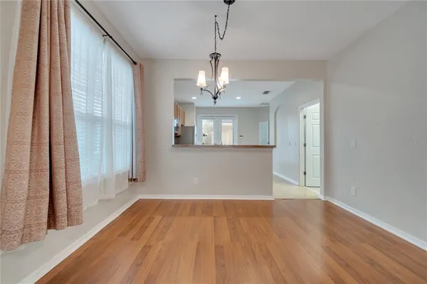 a view of a room with wooden floor and a window