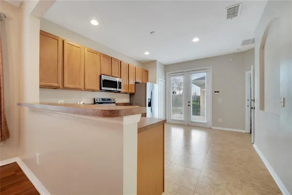 a kitchen with stainless steel appliances granite countertop a refrigerator a stove top oven a sink and dishwasher