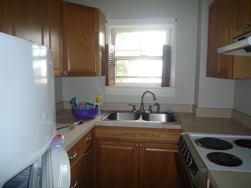 188 Cottage Street Fall River, MA 02721 - Photo 2 of 24 a kitchen with a sink cabinets and a window