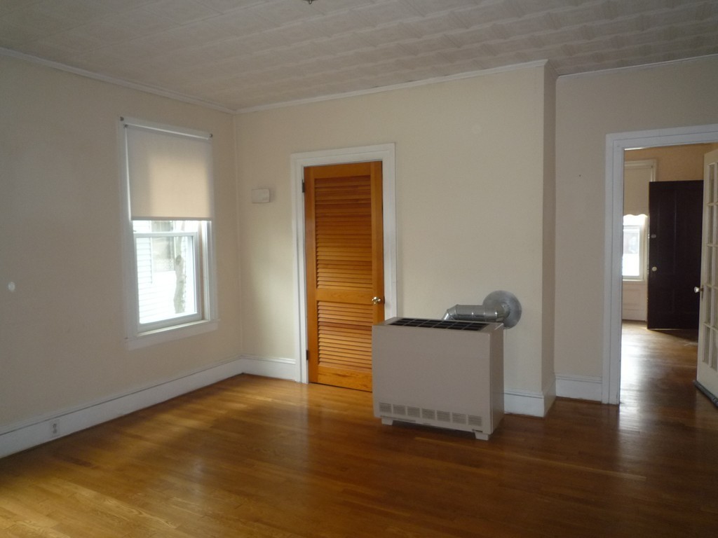 188 Cottage Street Fall River, MA 02721 - Photo 4 of 24 a view of a livingroom with wooden floor and a window