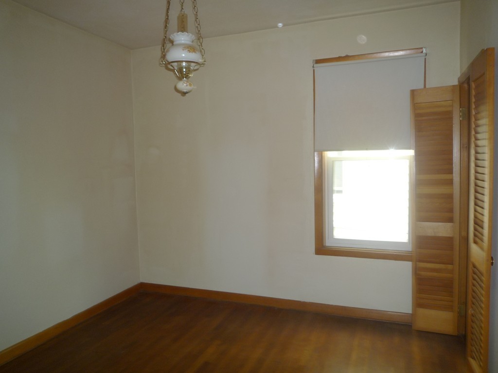 188 Cottage Street Fall River, MA 02721 - Photo 7 of 24 an empty room with a windows and chandelier fan