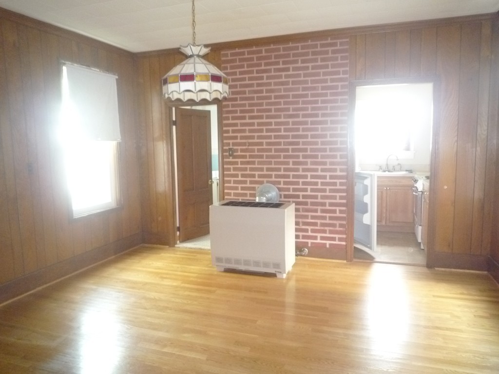 188 Cottage Street Fall River, MA 02721 - Photo 8 of 24 a view of a room with wooden floor and a window