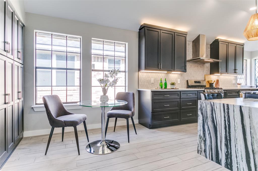 3913 Bobbin Lane Addison, TX 75001 - Photo 11 of 23 Kitchen featuring light wood-style flooring, backsplash, and light stone counters