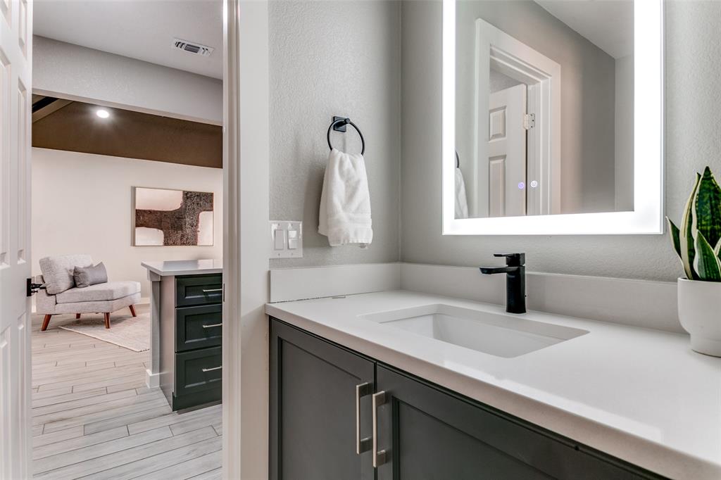 3913 Bobbin Lane Addison, TX 75001 - Photo 13 of 23 Bathroom featuring vanity and wood finish floors