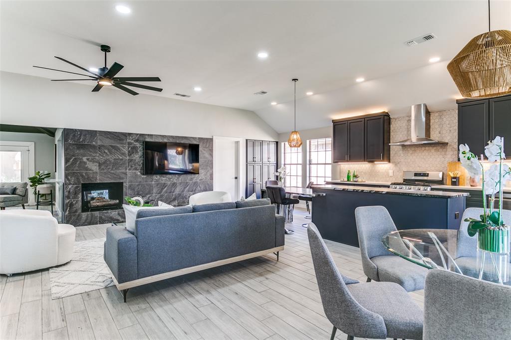 3913 Bobbin Lane Addison, TX 75001 - Photo 6 of 23 Living room with lofted ceiling, light wood-style flooring, a fireplace, ceiling fan, and recessed lighting