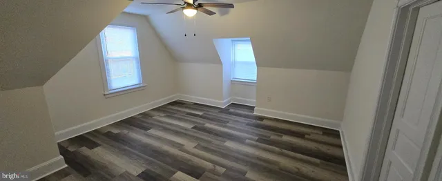 a view of a room with wooden floor and fan