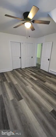 a view of a livingroom with a ceiling fan and window