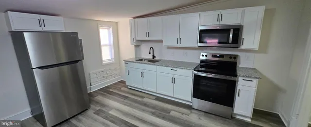 a kitchen with a refrigerator stove and microwave