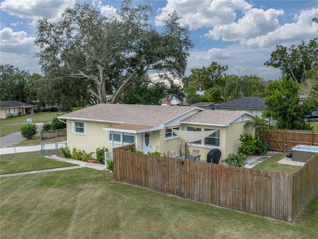 a view of a house with a big yard and large trees