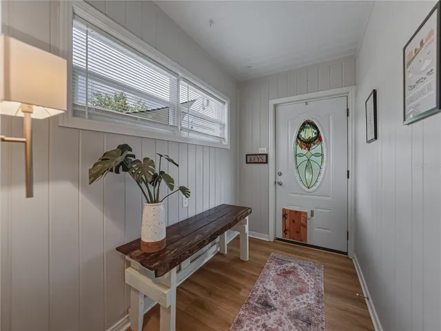 a kitchen with stainless steel appliances granite countertop a stove top oven a refrigerator a sink and dishwasher with wooden floor