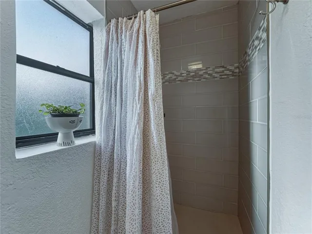 a view of backyard with wooden fence