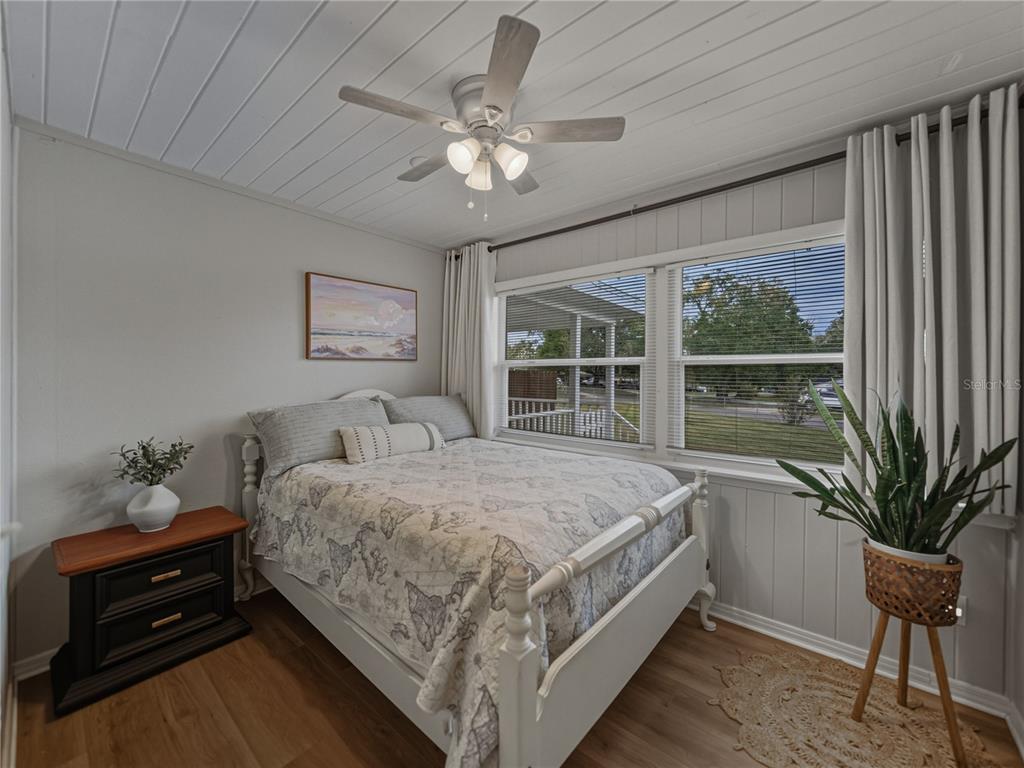 228 Azalea Street Lakeland, FL 33803 - Photo 39 of 80 a bedroom with a large bed and a chandelier