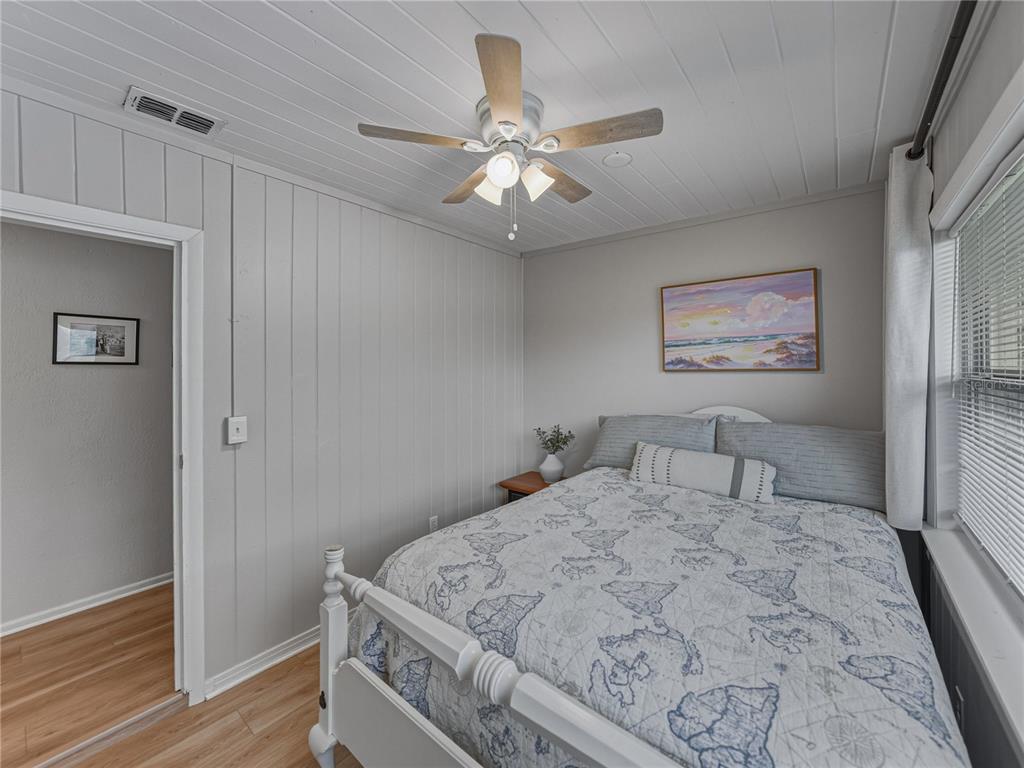 228 Azalea Street Lakeland, FL 33803 - Photo 41 of 80 a bedroom with a large bed and a chandelier