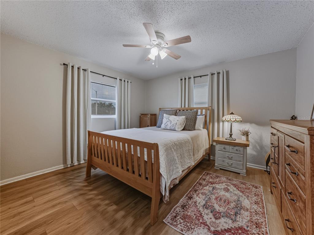 228 Azalea Street Lakeland, FL 33803 - Photo 42 of 80 a bedroom with a bed and a chandelier