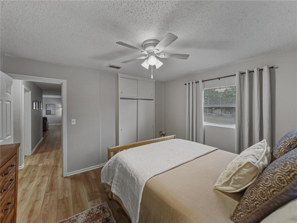 228 Azalea Street Lakeland, FL 33803 - Photo 44 of 80 a bedroom with a bed and a chandelier