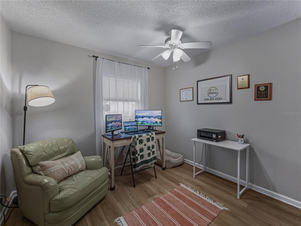 228 Azalea Street Lakeland, FL 33803 - Photo 46 of 80 a living room with furniture and a chandelier