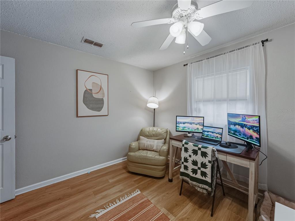 228 Azalea Street Lakeland, FL 33803 - Photo 47 of 80 a bedroom with furniture and a chandelier