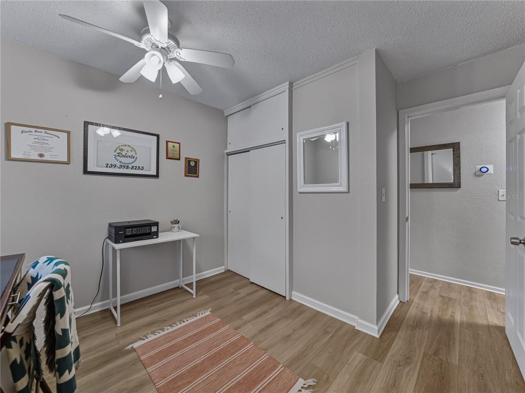 228 Azalea Street Lakeland, FL 33803 - Photo 49 of 80 a view of a workspace with furniture and wooden floor