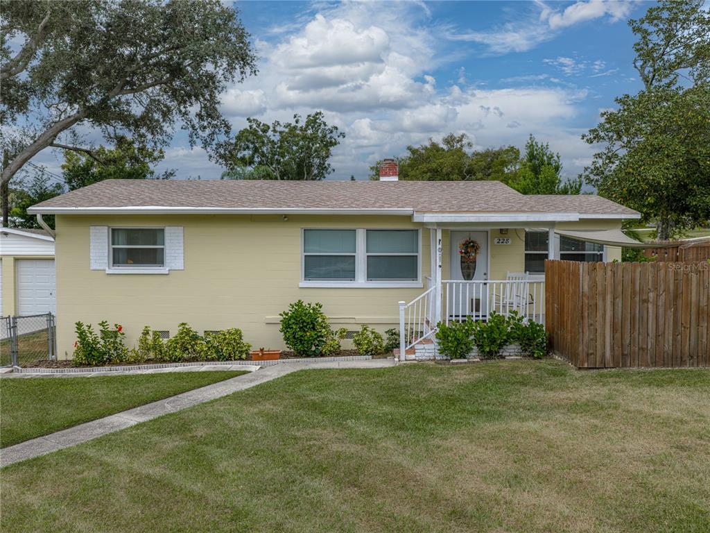 228 Azalea Street Lakeland, FL 33803 - Photo 5 of 80 a front view of a house with a garden