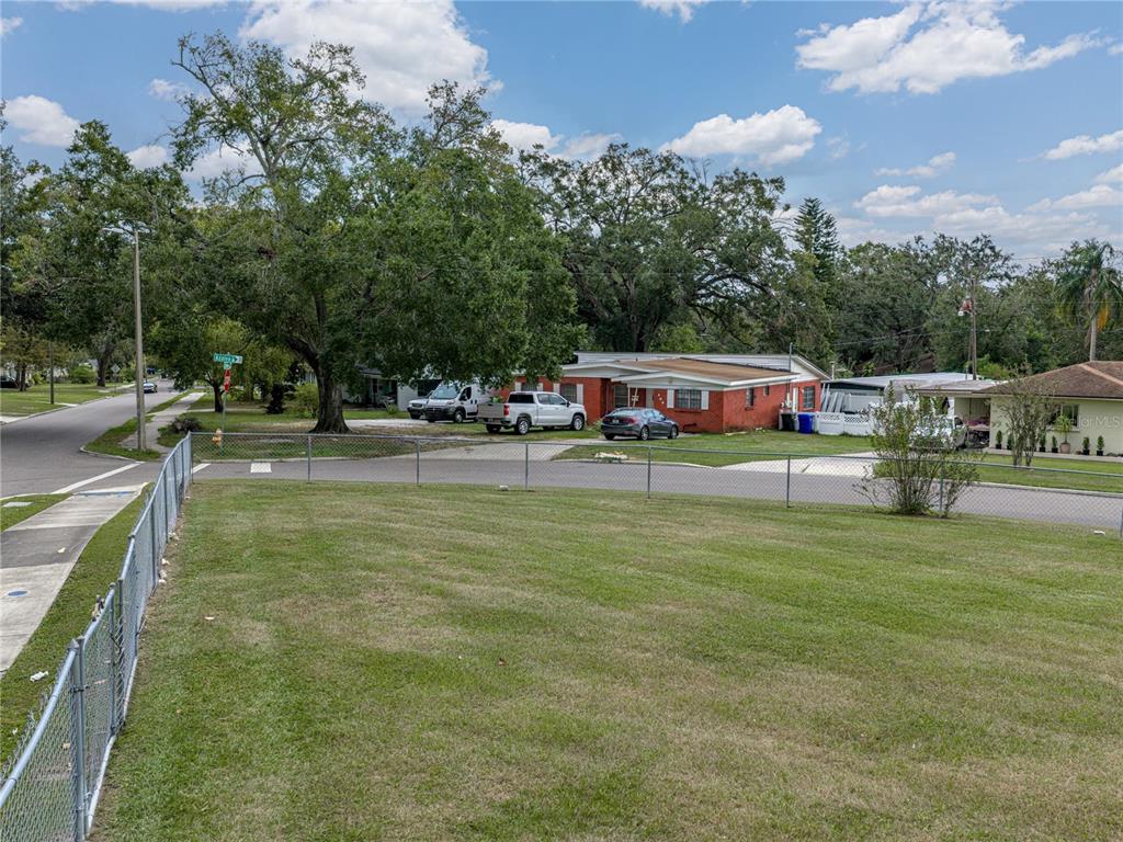 228 Azalea Street Lakeland, FL 33803 - Photo 9 of 80 a swimming pool view with a seating space and a garden