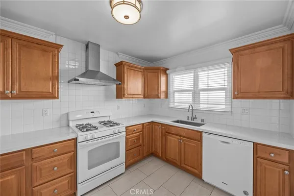 a kitchen with stainless steel appliances granite countertop a refrigerator and a stove