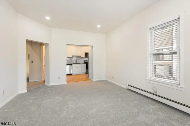 a kitchen with granite countertop white cabinets and stainless steel appliances