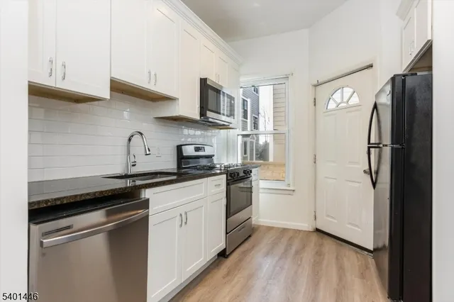 a kitchen with a sink stove and refrigerator