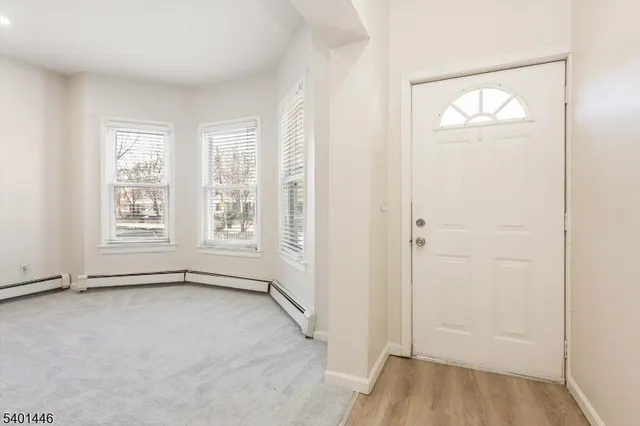 an empty room with windows and closet