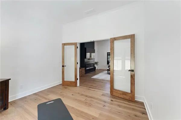a view of a hallway with wooden floor and staircase