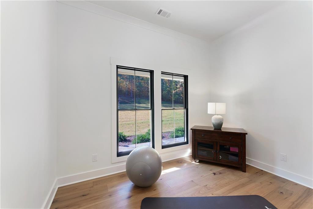100 Ridge Way Forsyth, GA 31029 - Photo 13 of 99 an empty room with wooden floor and windows