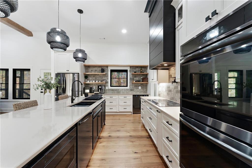 100 Ridge Way Forsyth, GA 31029 - Photo 17 of 99 a large kitchen with stainless steel appliances lots of counter space and a chandelier