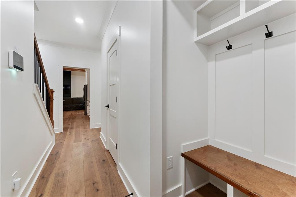 100 Ridge Way Forsyth, GA 31029 - Photo 25 of 99 a view of a hallway with wooden floor and staircase