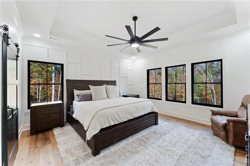 100 Ridge Way Forsyth, GA 31029 - Photo 33 of 99 a spacious bedroom with a large bed and a large window