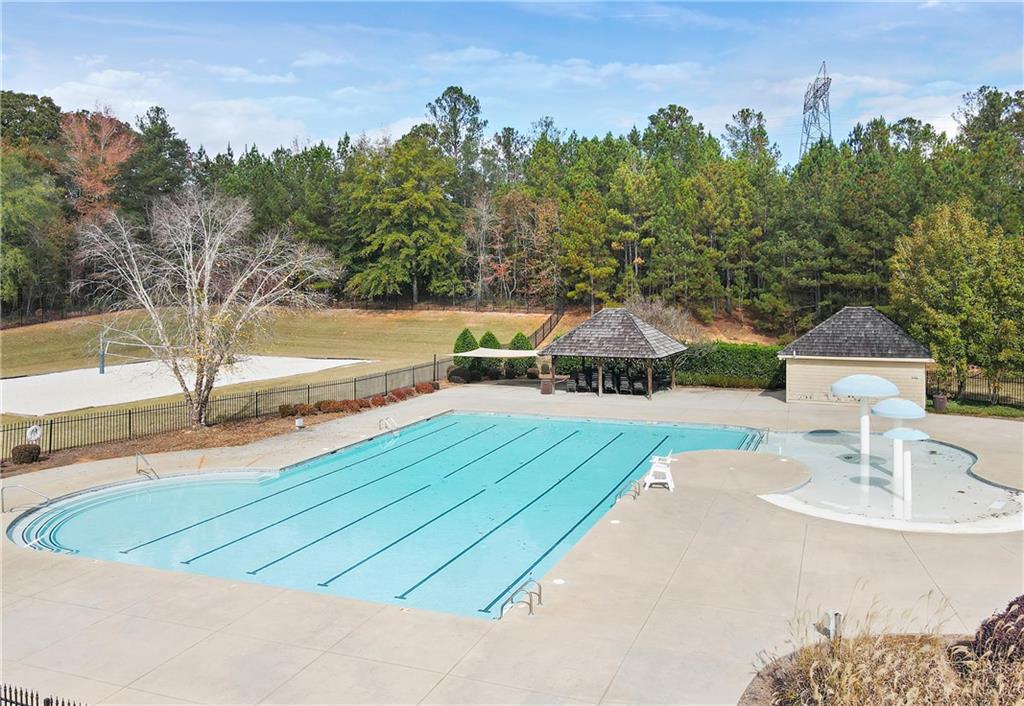 100 Ridge Way Forsyth, GA 31029 - Photo 67 of 99 a view of a swimming pool with a yard