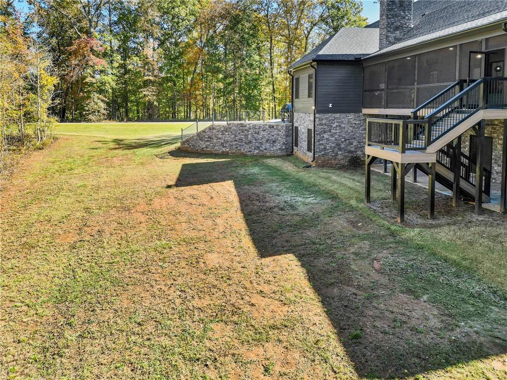 100 Ridge Way Forsyth, GA 31029 - Photo 83 of 99 a view of a backyard with plants and large trees
