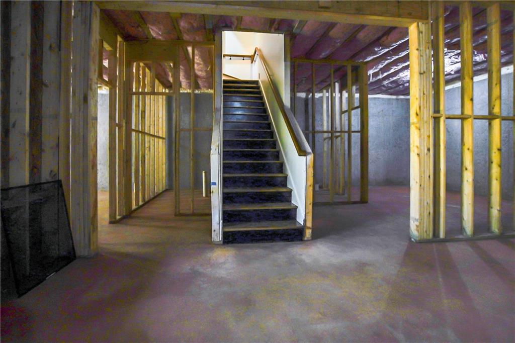 100 Ridge Way Forsyth, GA 31029 - Photo 90 of 99 a view of a hallway with staircase with white walls