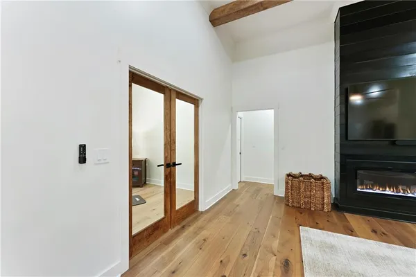 a large kitchen with stainless steel appliances lots of counter space and a chandelier
