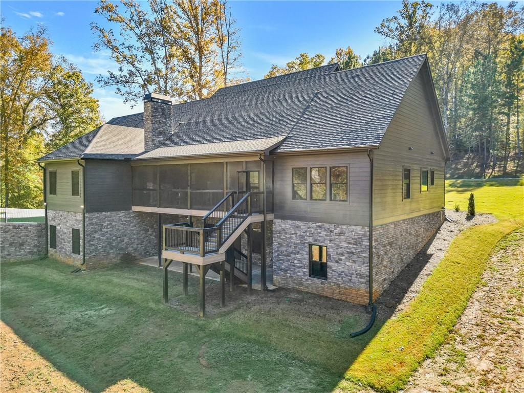 100 Ridge Way Forsyth, GA 31029 - Photo 97 of 99 a front view of a house with a yard table and chairs